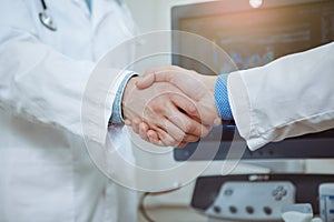 Male doctors shaking hands at the hospital