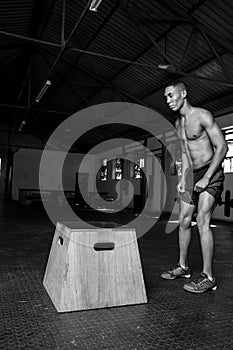 Male doing a box jump in a gym