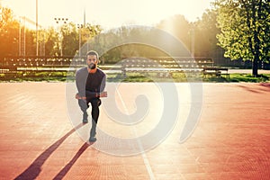 Male doing stretching exercise, preparing for morning workout in the park