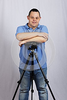 Male with down syndrome with the camera on white background