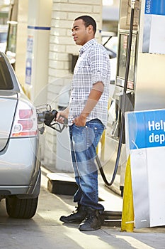 Male Driver Filling Car At Gas Station