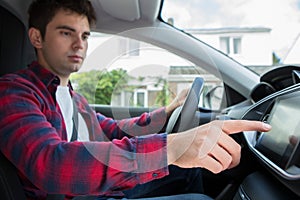 Male Driver Using Touchscreen In Car