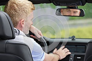 male driver using touchscreen in car