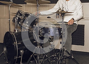 Male drum player hands holding cymbals with both hands and sticks. Drummer