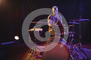 Male drummer performing in nightclub