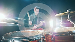 Male drummer is playing the drum set
