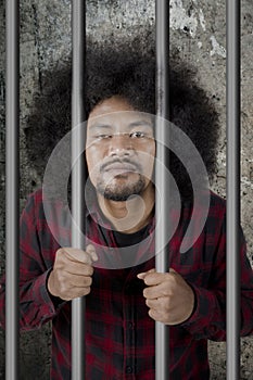 Male drunkard standing in the jail photo