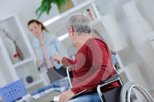 male elderly on wheelchair giving order