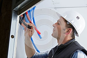 Male electrician checks serviceability