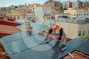 Male electrician engineer installing photovoltaic Solar Panels on city rooftop