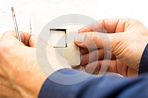 Male electrician putting cover on electric switch