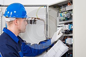 Male Electrician Testing Fusebox