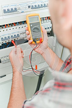 male electrician using device
