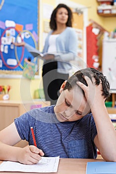 Male Elementary School Pupil Struggling In Class