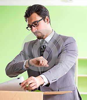 Male employee collecting his stuff after redundancy