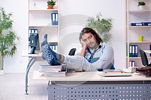 Male employee coming to work straight from bed