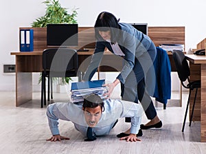 Male employee doing sport exercises in the office