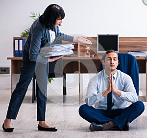 Male employee doing yoga exercises in the office