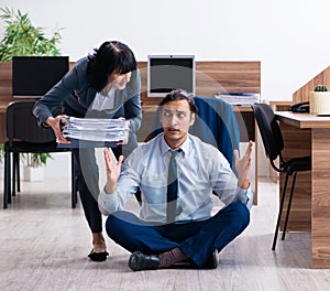 Male employee doing yoga exercises in the office