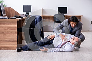 Male employee suffering from heart attack in the office