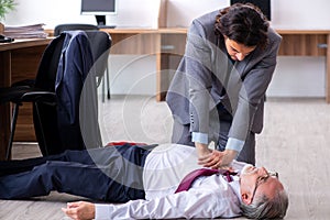 Male employee suffering from heart attack in the office