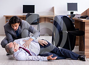 Male employee suffering from heart attack in the office