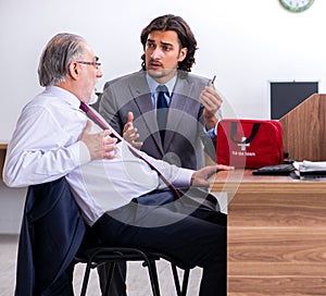 Male employee suffering from heart attack in the office