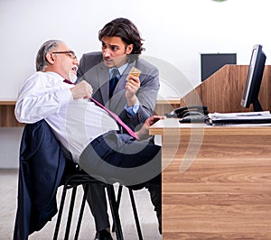 Male employee suffering from heart attack in the office