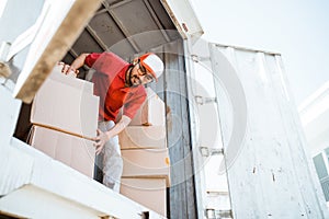 male employee working unloading boxes from containers