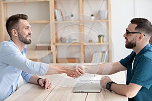 Male employer handshake job applicant greeting with employment