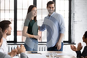 Male employer introduce new excited female employee at meeting