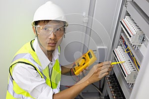 Male engineer checking electrical system with electronic equipment