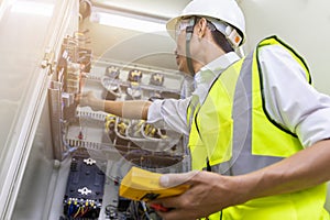 Male engineer checking electrical system with electronic equipment