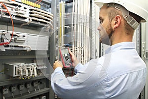 Male engineer are checking electrical system with electronic tools.