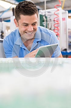 Male Engineer With Digital Tablet Working In Bottle Capping Fact