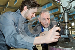 Male engineer in factory using milling machine