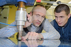 Male engineer in factory using milling machine