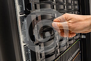 Male IT Engineer Replacing Server Drive in SAN At Datacenter