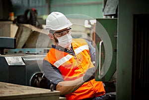 Male Engineer staff operating a cnc machine in factory