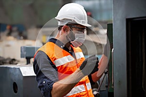 Male Engineer staff operating a cnc machine in factory