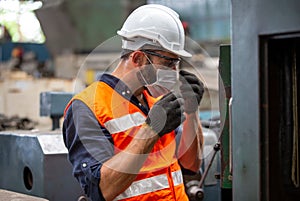 male Engineer staff operating a cnc machine in factory