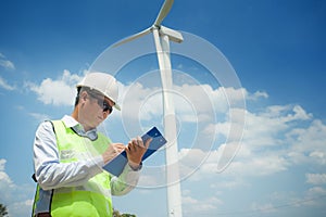 Male Engineer or tecnician at Work wind turbine generator station,,wind power concept photo