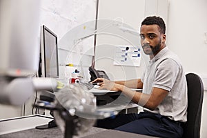 Male Engineer Uses CMM Coordinate Measuring Machine In Factory photo