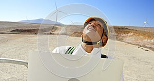 Male engineer using laptop in the wind farm 4k