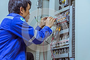 Male engineers are checking the electrical system with electronic tools, clamp-on, clip amp ,clamp meter