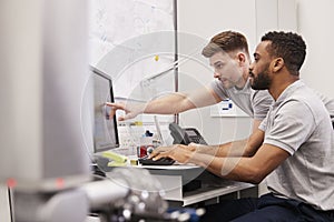 Male Engineers Use CMM Coordinate Measuring Machine In Factory