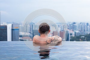 Male enjoying the view from infinity pool
