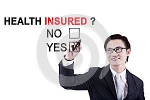 Male entrepreneur approving of health insured photo