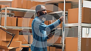 Male entrepreneur using scanner and tablet to check supplies inventory