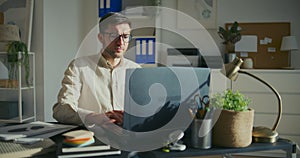 Male entrepreneur working on laptop at office